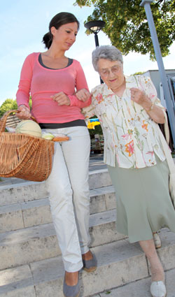 Caregiver with a patient walking outside