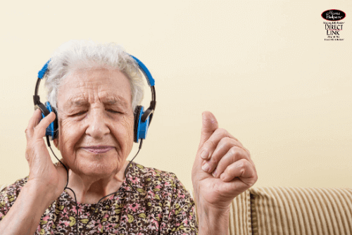 elderly woman listening to music to help with dementia 