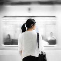 woman in front of a moving train