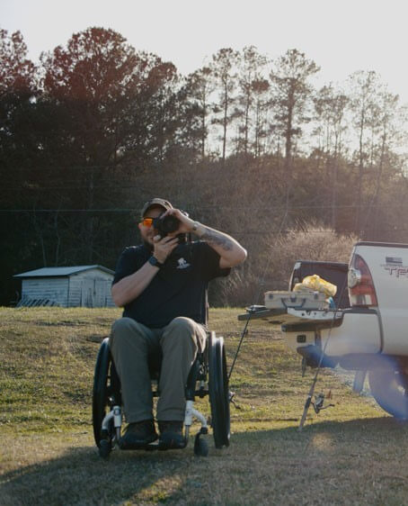 Man on a wheelchair taking pictures