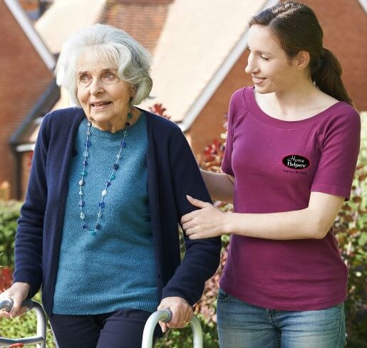 Home Helpers Caregiver holding elderly woman as they walk